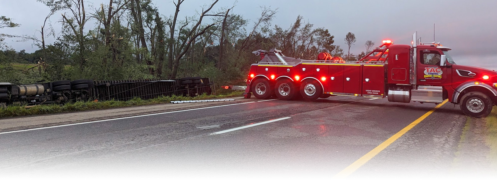 Image of Truck Towing Another Truck stumbled in the roadside.